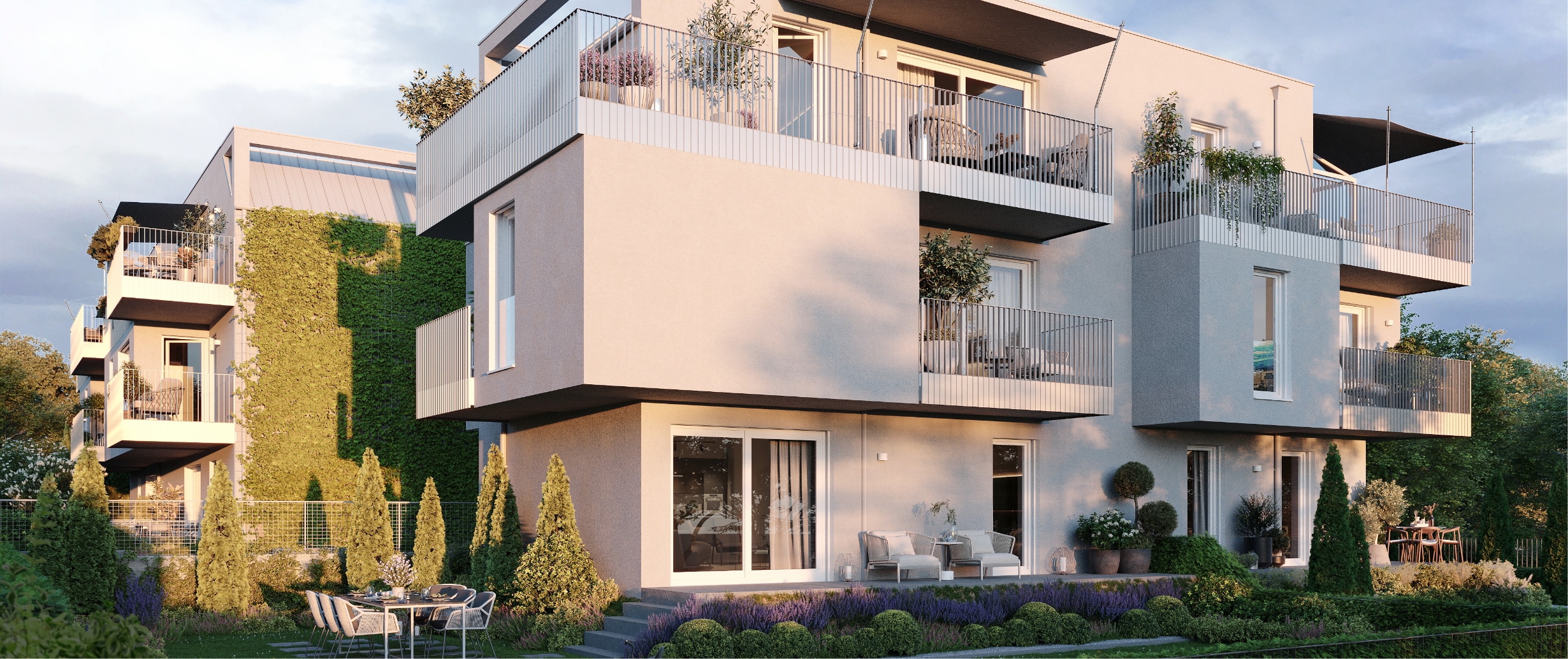 Wohngebäude mit begrünten Fassaden, großen Balkonen und liebevoll gestalteten Gartenbereichen.